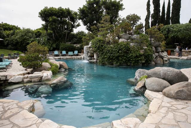 Hugh Hefner's Playboy Mansion is about to acquire a new owner — the wealthy businessman who lives next door (John Salangsang/Invision/AP)