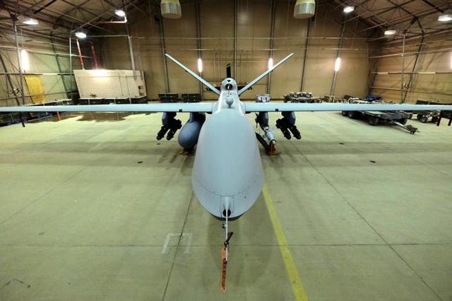 A US Air Force MQ-9 Reaper drone sits armed with Hellfire missiles and a 500-pound bomb in a hanger at Kandahar Airfield, Afghanistan March 9, 2016.