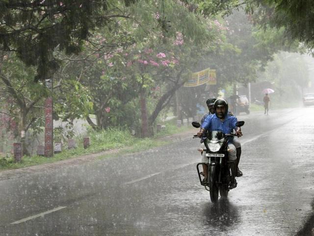 Men ride a motorbike in Thiruvananthapuram through the first pre-monsoon rains of Kerala on Tuesday. (Vivek R Nair / HT Photo) Men ride a motorbike in Thiruvananthapuram through the first pre-monsoon rains of Kerala on Tuesday. (Vivek R Nair / HT Photo)