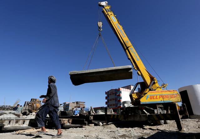 Afghan labourers install cement blast walls around Omid Khwajazada construction company in Kabul. (AP)