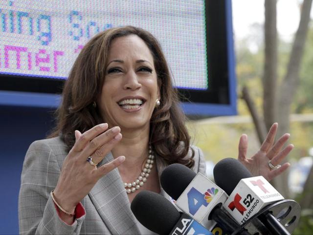 California attorney general Kamala Harris and her husband, Douglas Emhoff, vote at Kenter Canyon Elementary School in Los Angeles on Tuesday. The top two candidates for California's first open US Senate seat in 24 years will advance to a run-off election in November to replace retiring Barbara Boxer. Harris is a heavy favourite and fellow Democrat Loretta Sanchez is looking to hold off three Republican challengers for second place. (AP) California attorney general Kamala Harris and her husband, Douglas Emhoff, vote at Kenter Canyon Elementary School in Los Angeles on Tuesday. The top two candidates for California's first open US Senate seat in 24 years will advance to a run-off election in November to replace retiring Barbara Boxer. Harris is a heavy favourite and fellow Democrat Loretta Sanchez is looking to hold off three Republican challengers for second place. (AP)