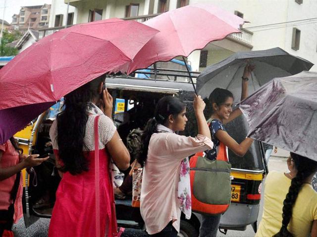 A woman-child duo dressed up in raincoats riding a scooter during the pre-monsoon rains in Kochi. (PTI) A woman-child duo dressed up in raincoats riding a scooter during the pre-monsoon rains in Kochi. (PTI)