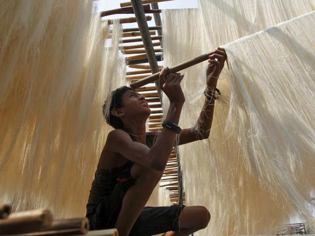 A boy hangs arranges strands of vermicelli, which is eaten during Ramzan, to dry at a factory in Allahabad. (REUTERS) A boy hangs arranges strands of vermicelli, which is eaten during Ramzan, to dry at a factory in Allahabad. (REUTERS)