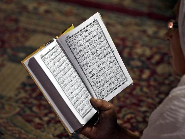 A Muslim woman reads the Quran at the shrine of Sheikh Abdul Qadir Jeelani, a Sufi saint, in Srinagar. Large congregations were held at all other major towns and cities in Kashmir and the Jammu region. (REUTERS) A Muslim woman reads the Quran at the shrine of Sheikh Abdul Qadir Jeelani, a Sufi saint, in Srinagar. Large congregations were held at all other major towns and cities in Kashmir and the Jammu region. (REUTERS)