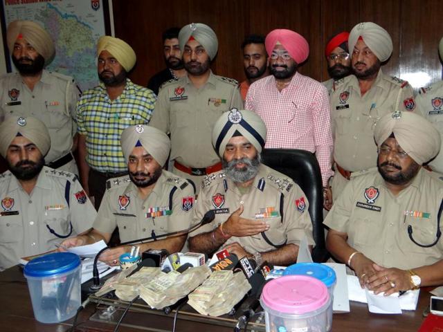 Ferozepur range deputy inspector general of police Ranbir Singh Khatra (centre) addressing a press conference in Moga on Tuesday. (HT Photo) Ferozepur range deputy inspector general of police Ranbir Singh Khatra (centre) addressing a press conference in Moga on Tuesday. (HT Photo)