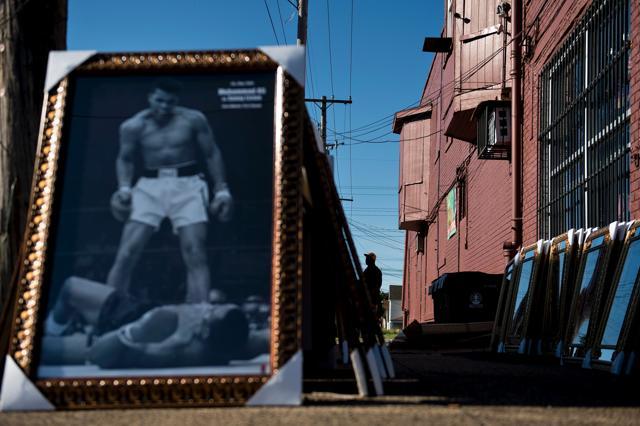 A framed portrait of Muhammad Ali is displayed for sale at Broadway Fashion in Louisville, Kentucky, as the city prepares for the boxing legend's memorial and funeral. (AFP Photo) A framed portrait of Muhammad Ali is displayed for sale at Broadway Fashion in Louisville, Kentucky, as the city prepares for the boxing legend's memorial and funeral. (AFP Photo)