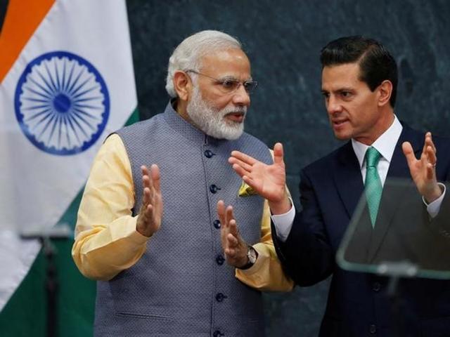 Prime Minister Narendra Modi speaks with Mexican President Enrique Pena Nieto after they gave a speech, at Los Pinos presidential residence in Mexico City.(Reuters)