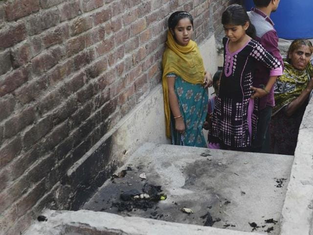 Pakistani residents stand at the site where Zeenat Bibi was burnt alive by her mother in Lahore on Wednesday. (AFP) Pakistani residents stand at the site where Zeenat Bibi was burnt alive by her mother in Lahore on Wednesday. (AFP)