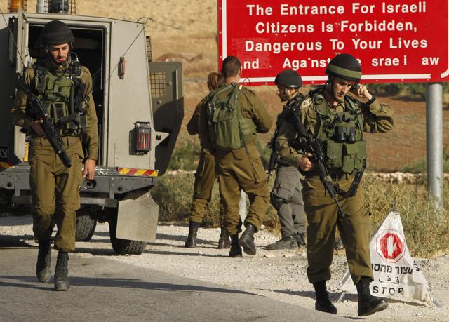 Israeli soldiers in the Palestinian village of Yatta in the occupied West Bank on Thursday, a day after an attack in the Israeli city of Tel Aviv left four people dead and 16 others wounded. (AFP) Israeli soldiers in the Palestinian village of Yatta in the occupied West Bank on Thursday, a day after an attack in the Israeli city of Tel Aviv left four people dead and 16 others wounded. (AFP)