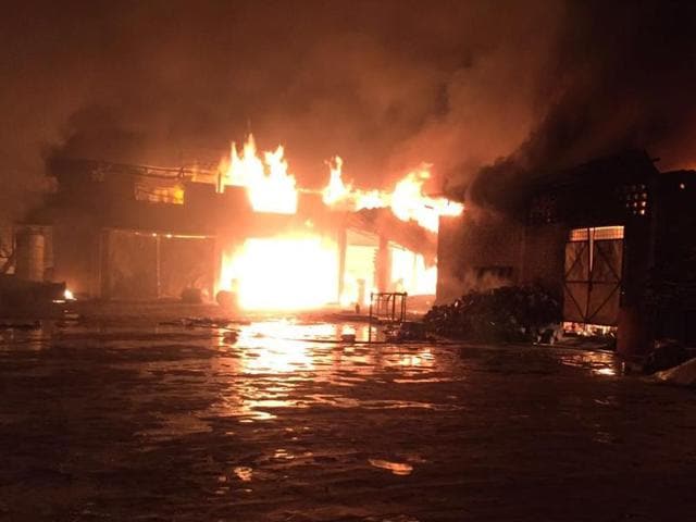 A major fire at a paint manufacturing unit in Kangniwal village in Jalandhar on Friday.(HT Photo)