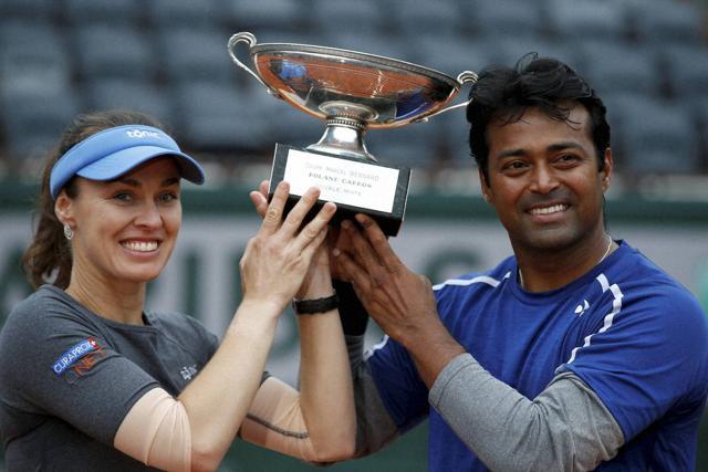 Switzerland’s Martina Hingis (left) and Leander Paes hold the trophy after winning the mixed doubles final of the French Open tennis tournament. (AP F File Photo)