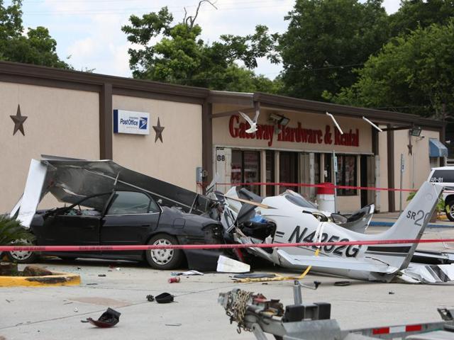 The wreckage of a small plane that crashed into a car in a parking lot near a Houston airport.(AP)