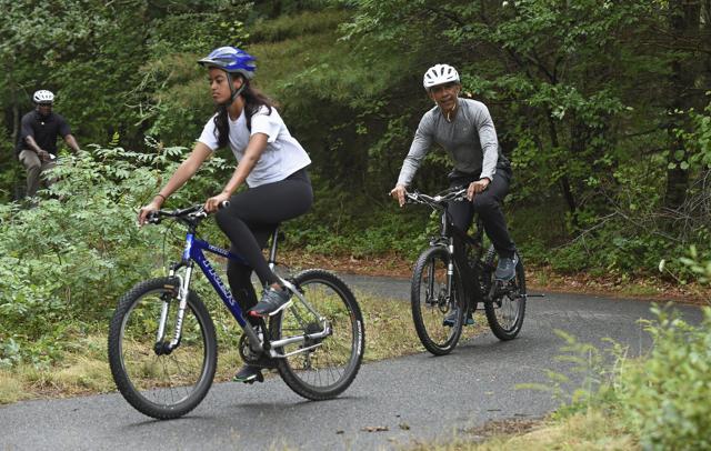 In this file photo, US President Barack Obama follows Malia as they rides their bikes in West Tisbury. (AP) In this file photo, US President Barack Obama follows Malia as they rides their bikes in West Tisbury. (AP)