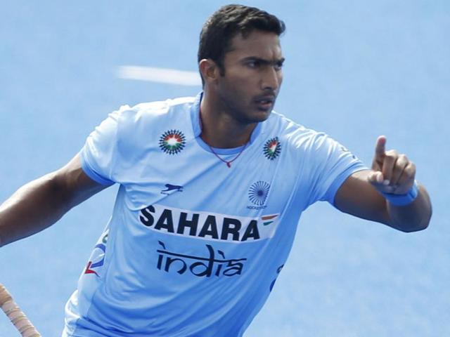 India's Raghunath Vokkaliga celebrates scoring the first goal during the Pool game between Germany and India.(AP Photo)