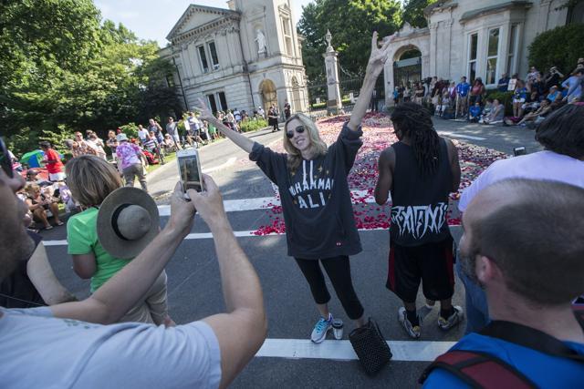Carrie Williamson of Louisville poses for a photograph as spectators wait for the arrival of Muhammad Ali's funeral procession to enter Cave Hill Cemetery. (AP Photo)