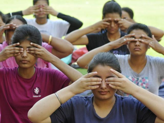 Students and others taking part in yoga camp at Guru Gobind Singh College, Sector 26 , on Wednesday. (Karun Sharma/HT Photo)