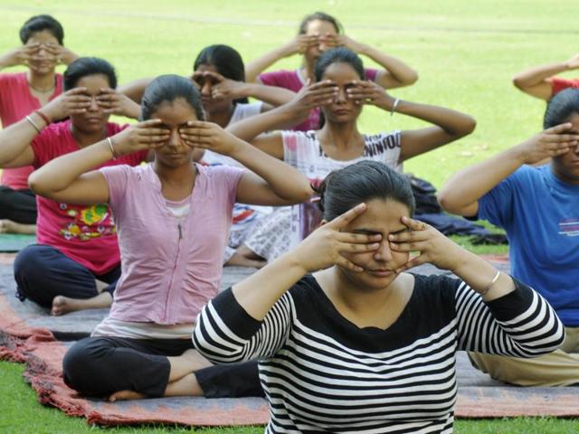 Students doing yoga at Guru Gobind Singh College, Sector 26. (HT File Photo)