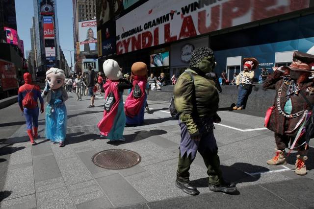 Costumed characters who pose for tips gather on a sidewalk in New York's Times Square, US June 9, 2016. (Reuters) Costumed characters who pose for tips gather on a sidewalk in New York's Times Square, US June 9, 2016. (Reuters)
