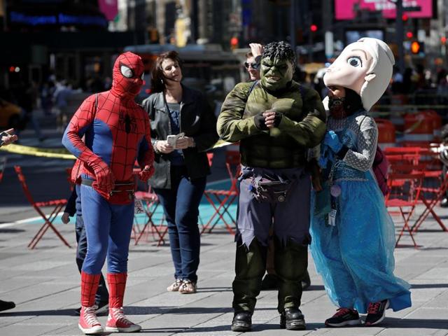 Costumed characters who pose for tips gather on a sidewalk in New York's Times Square, US June 9, 2016, where starting on June 21, 2016, the New York City Police Department (NYPD) will begin enforcing rules restricting characters, performers and other commercial activity to designated areas. (Reuters) Costumed characters who pose for tips gather on a sidewalk in New York's Times Square, US June 9, 2016, where starting on June 21, 2016, the New York City Police Department (NYPD) will begin enforcing rules restricting characters, performers and other commercial activity to designated areas. (Reuters)