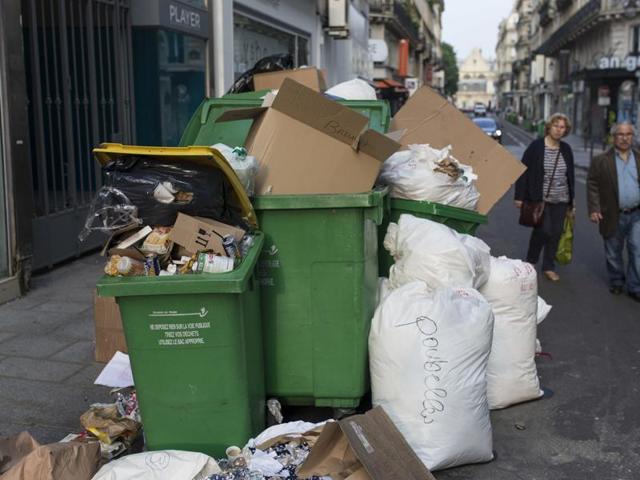 People walk past a dustbin and a pile of rubbish bags in Paris, France. The eyes of the continent are on France as the Euro 2016 tournament kicks off. (AP Photo) People walk past a dustbin and a pile of rubbish bags in Paris, France. The eyes of the continent are on France as the Euro 2016 tournament kicks off. (AP Photo)