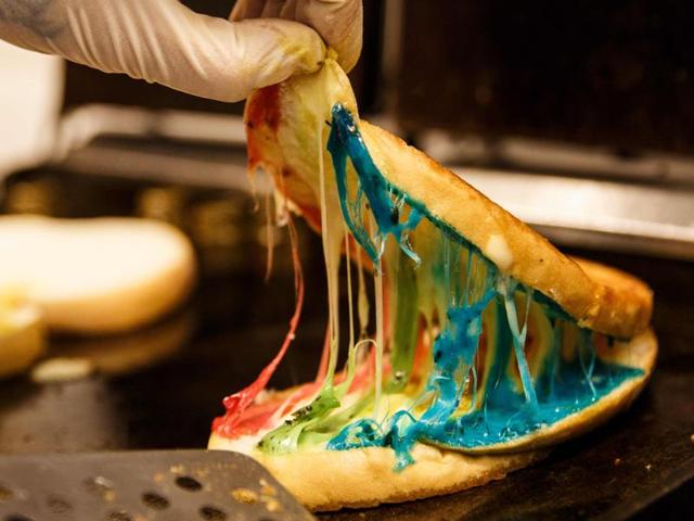 In this picture taken on June 8, 2016, an employee prepares a Rainbow Coloured Toast cheese sandwich at Kala Toast in the Hong Kong suburb of Tsuen Wan. (AFP) In this picture taken on June 8, 2016, an employee prepares a Rainbow Coloured Toast cheese sandwich at Kala Toast in the Hong Kong suburb of Tsuen Wan. (AFP)