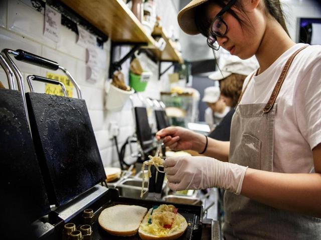 Pictures of the toast have proven to be a social media hit with customers posting images of the multicoloured strings of cheese being stretched apart. (AFP) Pictures of the toast have proven to be a social media hit with customers posting images of the multicoloured strings of cheese being stretched apart. (AFP)
