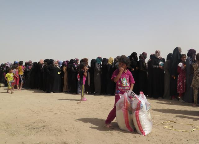 Displaced Iraqi families, who fled their homes in and around Fallujah due to fighting between Iraqi government forces and the Islamic State (IS) group, queue for food rations and other emergency supplies at a camp run by the Norwegian Refugee Council (NRC) in the town of Amriyat al-Fallujah. (AFP) Displaced Iraqi families, who fled their homes in and around Fallujah due to fighting between Iraqi government forces and the Islamic State (IS) group, queue for food rations and other emergency supplies at a camp run by the Norwegian Refugee Council (NRC) in the town of Amriyat al-Fallujah. (AFP)