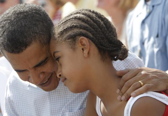 In this file photo, Obama is seen talking to Malia as they watch an Independence Day parade in Butte. (AP) In this file photo, Obama is seen talking to Malia as they watch an Independence Day parade in Butte. (AP)