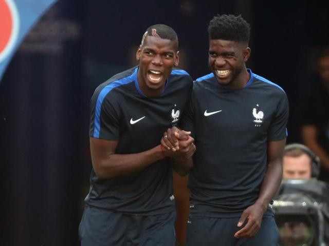 Paul Pogba, left and Samuel Umtiti share a lighter moment. (AP) 