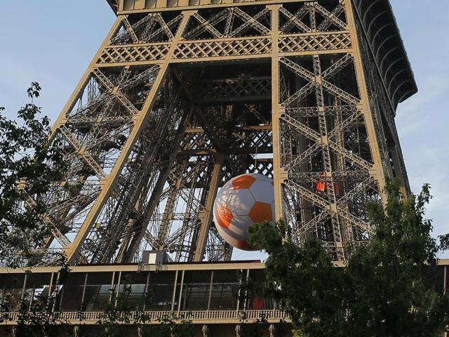 A giant football hangs under the Eiffel Tower as part of the run-up to Euro 2016. (AP)