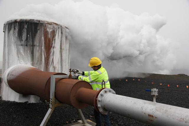 In this July 28, 2011 file photo, a CarbFix experiment's technical manager, checks a valve at a test well at Reykjavik Energy's Hellisheidi geothermal power plant in Iceland. Scientists have a found a quick but not cheap way to turn heat-trapping carbon dioxide into harmless rock. (AP)