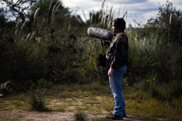 Juan Pablo Culasso stands with his recording equipment in a natural reserve on the outskirts of Montevideo, Uruguay.(AP Photo)