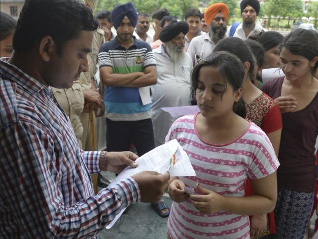 Students getting their admit cards checked at Punjab PMET’s Amritsar centre on Saturday. (Gurpreet Singh/HT Photo) Students getting their admit cards checked at Punjab PMET’s Amritsar centre on Saturday. (Gurpreet Singh/HT Photo)