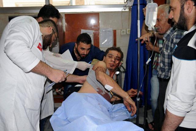 In this photo released by the Syrian official news agency SANA, doctors treat a man at a hospital in Damascus who was injured in the bombing attack in the Sayeda Zeinab suburb, Syria on Saturday. (AP) In this photo released by the Syrian official news agency SANA, doctors treat a man at a hospital in Damascus who was injured in the bombing attack in the Sayeda Zeinab suburb, Syria on Saturday. (AP)
