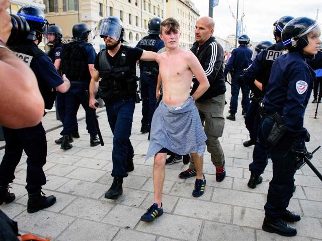 An England fan (C) is detained following clashes between England fans and police personnel in Marseille (AFP) An England fan (C) is detained following clashes between England fans and police personnel in Marseille (AFP)