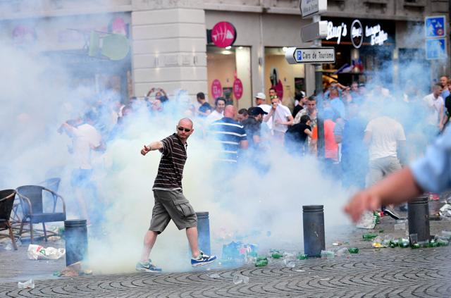 An England fan walks through tear gas released by French police as England fans gather in the port area of Marseille. (AFP Photo) An England fan walks through tear gas released by French police as England fans gather in the port area of Marseille. (AFP Photo)