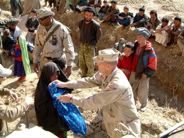 File photo of US civil affairs soldier based with a Provincial Reconstruction team hand out humanitarian relief to local Afghans in Bamiyan province.(Reuters Photo)