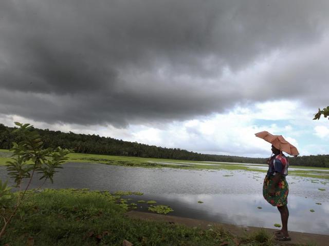 People, holding umbrellas, walk at a road during the first monsoon rains in Kochi . (PTI) People, holding umbrellas, walk at a road during the first monsoon rains in Kochi . (PTI)