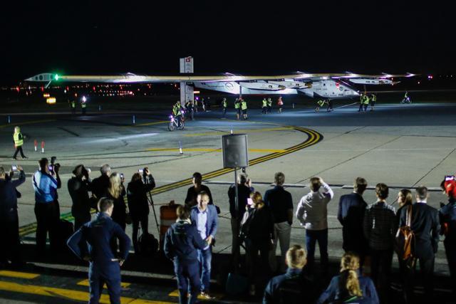 People watch the arrival of the Solar Impulse 2 aircraft following its successful landing at JFK International Airport in Queens, New York on Saturday. (AFP) People watch the arrival of the Solar Impulse 2 aircraft following its successful landing at JFK International Airport in Queens, New York on Saturday. (AFP)
