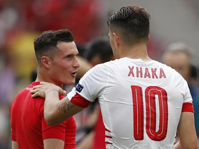 Granit and Taulant Xhaka exchanged hugs at the end of the game. (REUTERS) Granit and Taulant Xhaka exchanged hugs at the end of the game. (REUTERS)