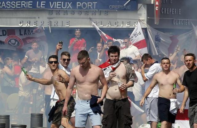 England fans reacted to tear gas being fired by throwing beer bottles and other projectiles. (Reuters) England fans reacted to tear gas being fired by throwing beer bottles and other projectiles. (Reuters)