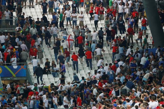 England fans try to escape the charging Russian fans in the stadium. (Reuters) England fans try to escape the charging Russian fans in the stadium. (Reuters)