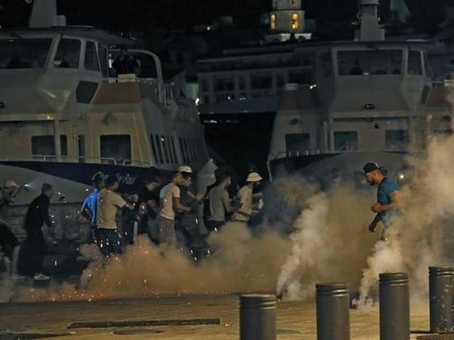 The violence continued outside the stadium after the game as well, with police resorting to tear gas to disperse fans. (Reuters) The violence continued outside the stadium after the game as well, with police resorting to tear gas to disperse fans. (Reuters)
