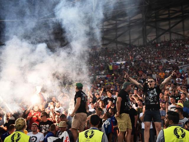 Russia supporters chant slogans and light flares in the stands. (AFP) Russia supporters chant slogans and light flares in the stands. (AFP)