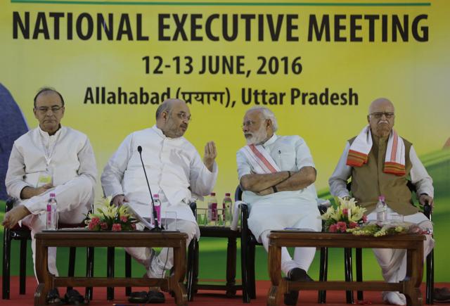 Prime Minister Narendra Modi listens to Bharatiya Janata Party (BJP) president Amit Shah during the party's two-day national executive meeting in Allahabad.(AP)