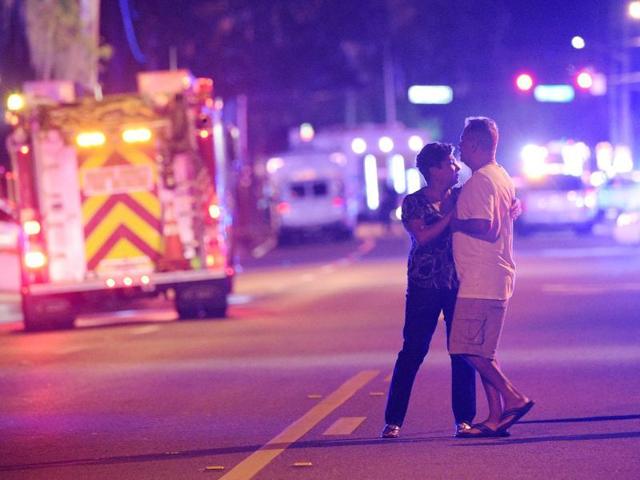 Family members wait for word from police after arriving down the street from a shooting involving multiple fatalities at Pulse Orlando nightclub in Orlando, Florida.(AP)