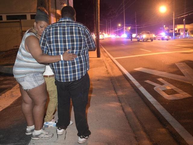 Bystanders wait down the street from a multiple shooting at the Pulse nightclub in Orlando.(AP)