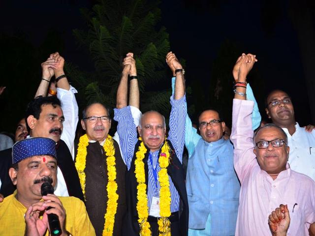 BJP candidates Anil Madhav Dave and MJ Akbar celebrate after winning the Rajya Sabha elections.(Praveen Bajpai/HT photo)