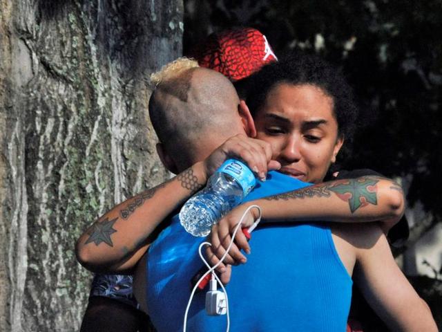 Friends and family members embrace outside the Orlando Police headquarters during the investigation of a shooting at the Pulse nightclub, where people were killed by a gunman, in Orlando, Florida.(REUTERS)