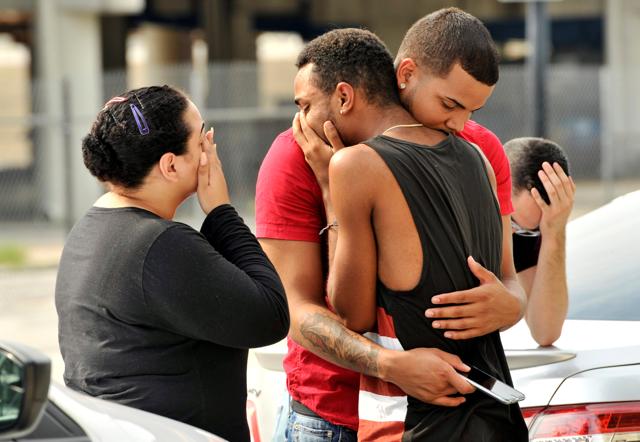 Friends and family members embrace outside the Orlando Police Headquarters during the investigation of a shooting at the Pulse night club, where as many as 20 people were killed after a gunman opened fire, in Orlando, Florida. (Reuters) Friends and family members embrace outside the Orlando Police Headquarters during the investigation of a shooting at the Pulse night club, where as many as 20 people were killed after a gunman opened fire, in Orlando, Florida. (Reuters)